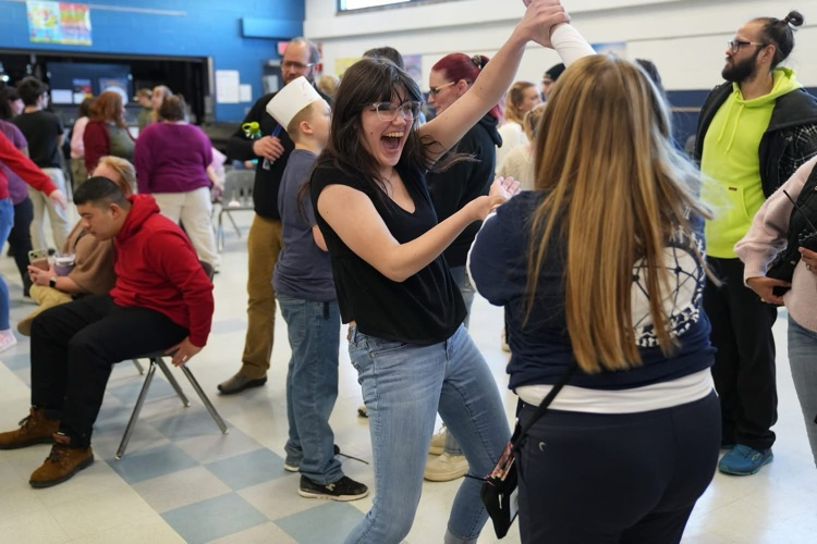  Students and staff smile and dance together at the Smith School Friendship Dance