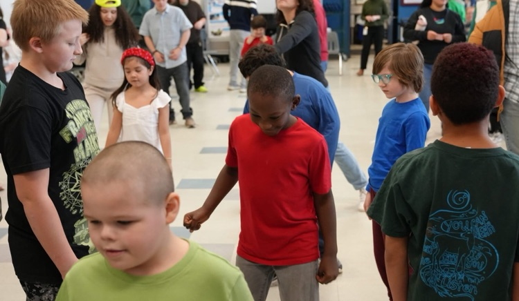 a group of young students dancing at the St. Patrick’s Day Dance