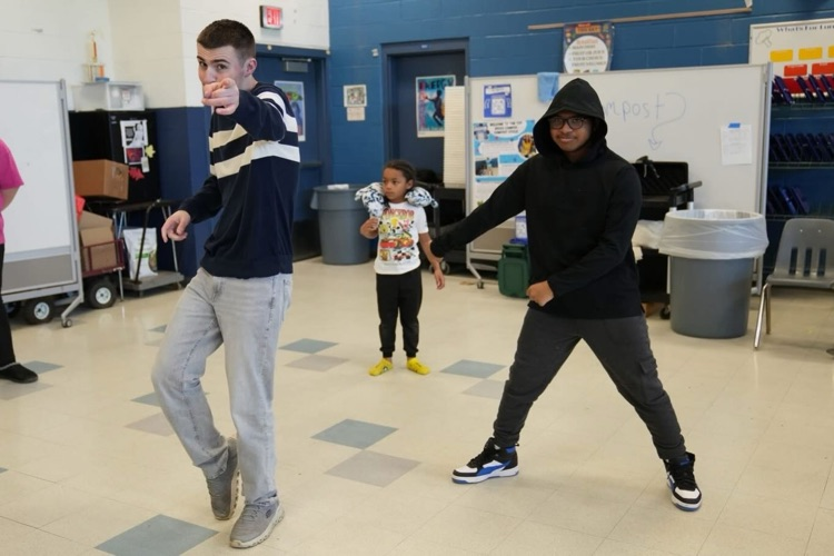a group of young students dancing at the St. Patrick’s Day Dance