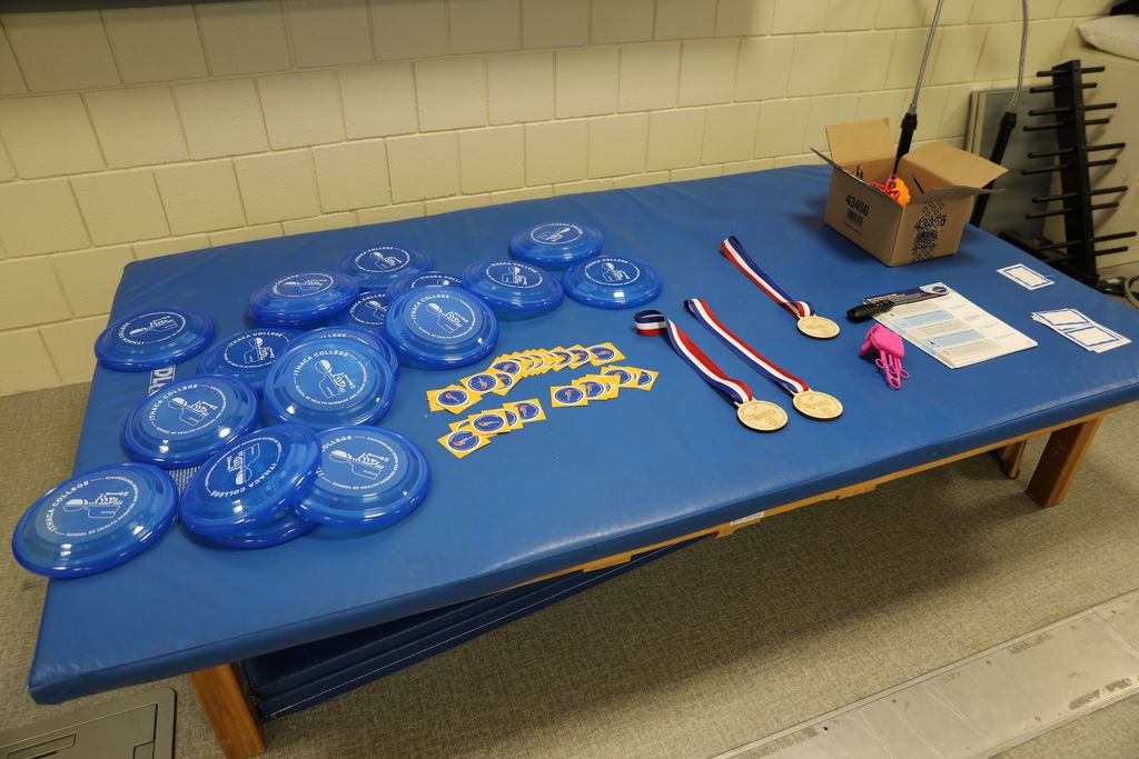 A table full of frisbees and other swag items to give to the students