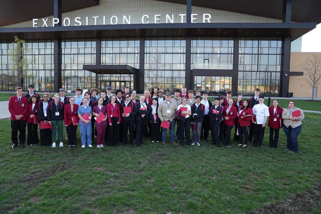 Group of TST skillsusa competitiors standing outside of the the Exposition Center