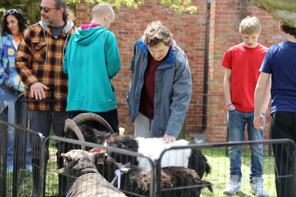 a student petting the goat