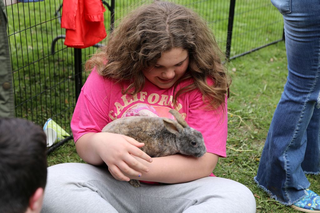 a student holding a rabbit