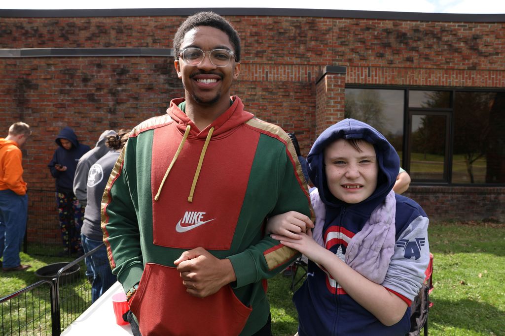 a student and staff member posing for a photo