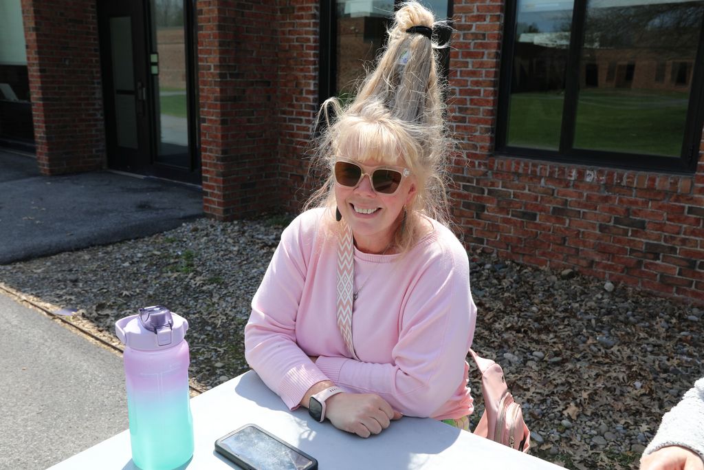 a staff member with wacky hair smiling at camera
