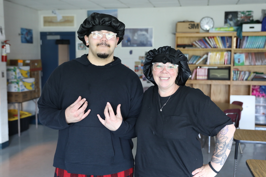 a student and staff member posing for a photo