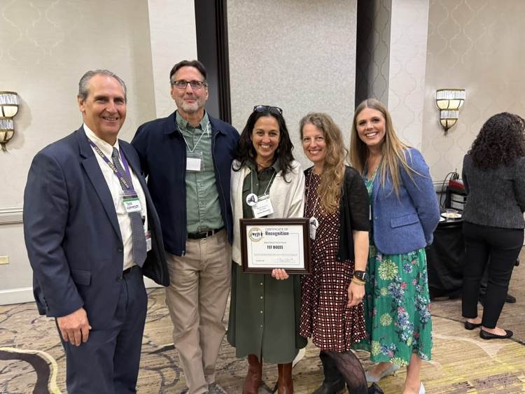 Dr. Matteson, Mr. Barr, Dr. Dhundale, Ms. Jessica Hoff and Ms. Talcott smile and hold award