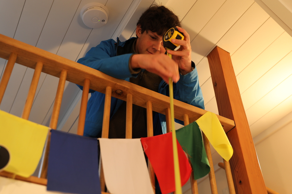 A student measuring the height of the PowerHouse