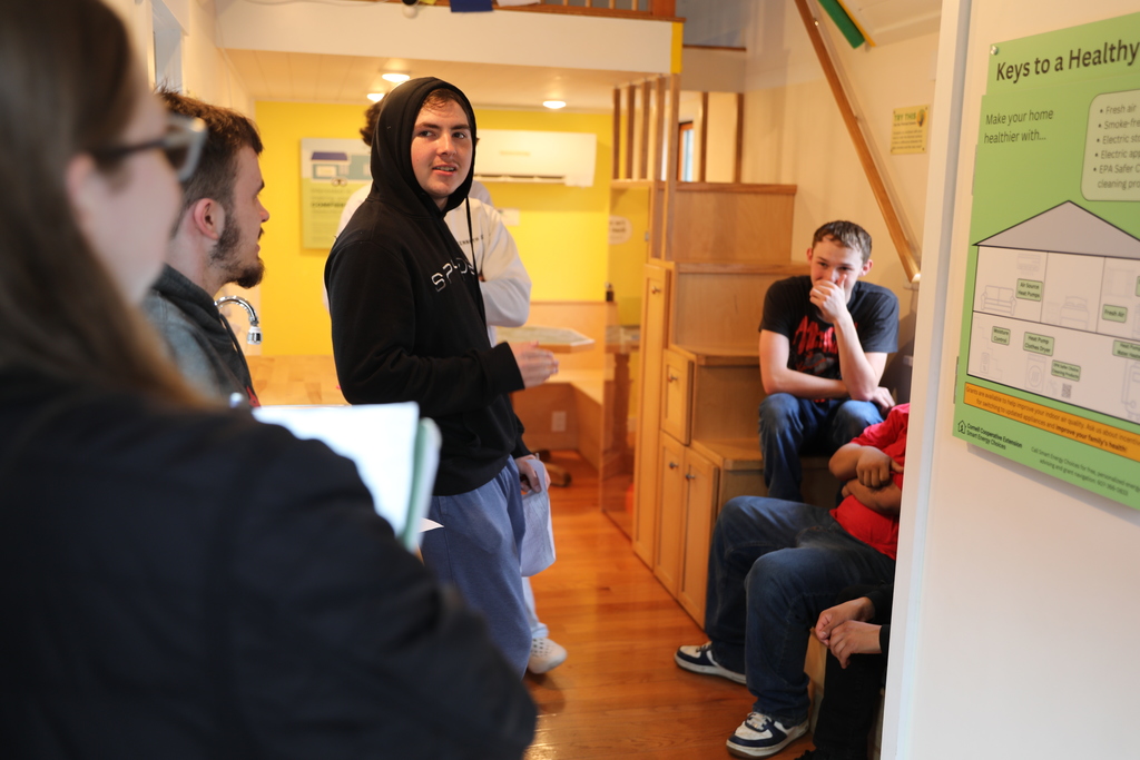 A staff members explaining to students how the PowerHouse works