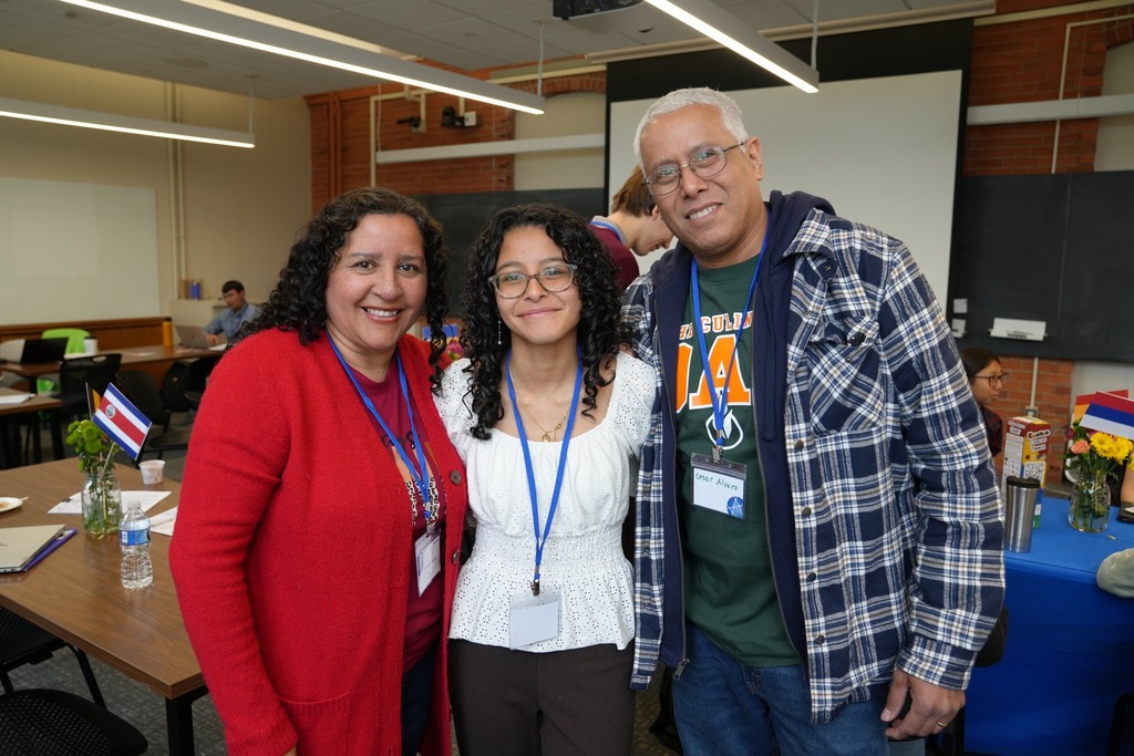 A student participant poses with family members who also served as panel judges during the Regional Seal of Biliteracy Presentation Day
