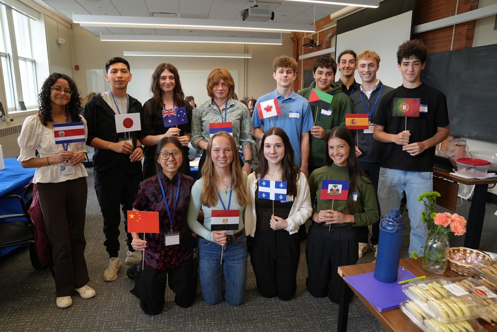Students from Dryden CSD pose together during the Regional Seal of Biliteracy Presentation Day, with several students holding flags representing different languages and cultures.