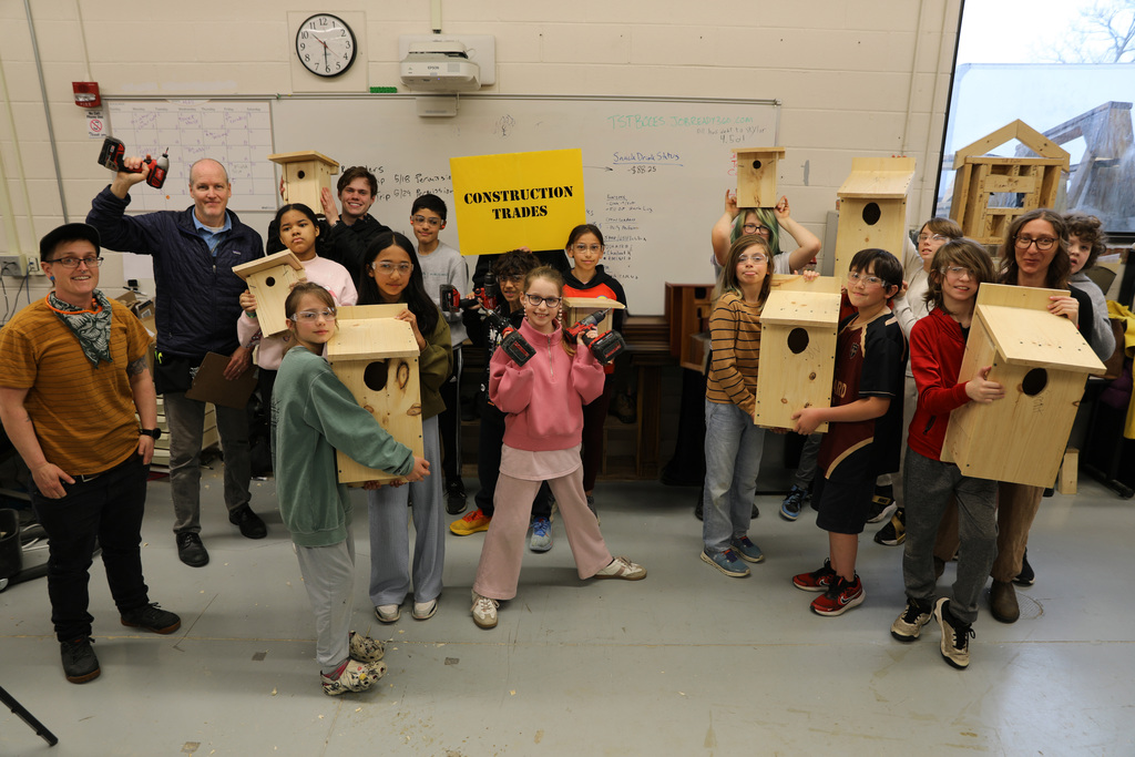 a group photo of students after building bird houses