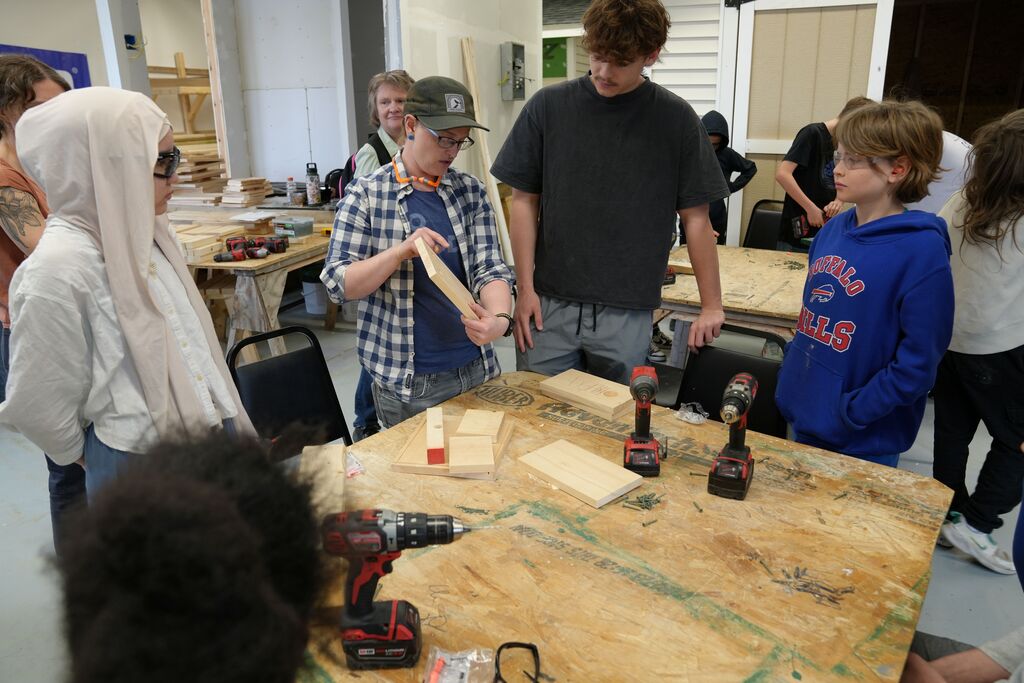 a few students listening to the teacher explaining how to drill
