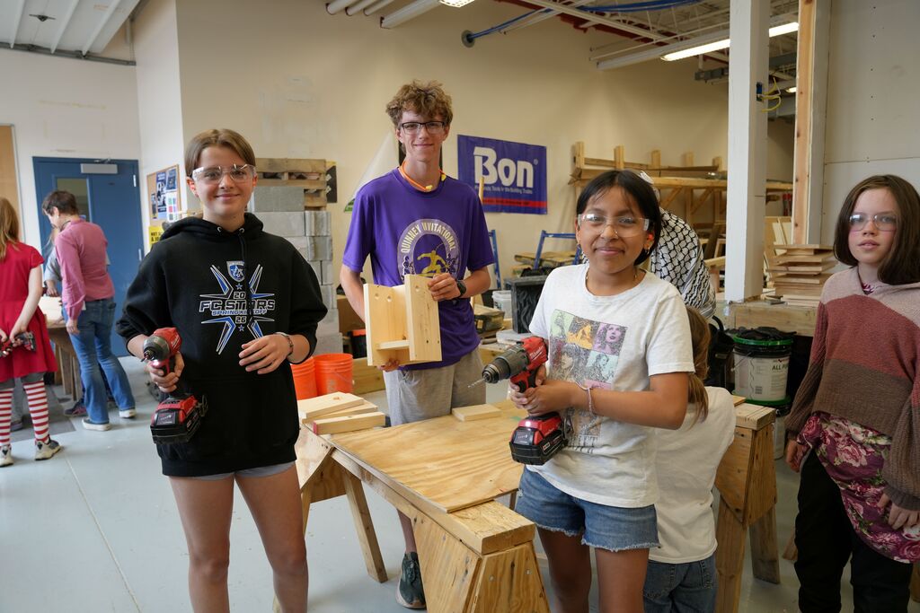 Some students holding up their birdhouse