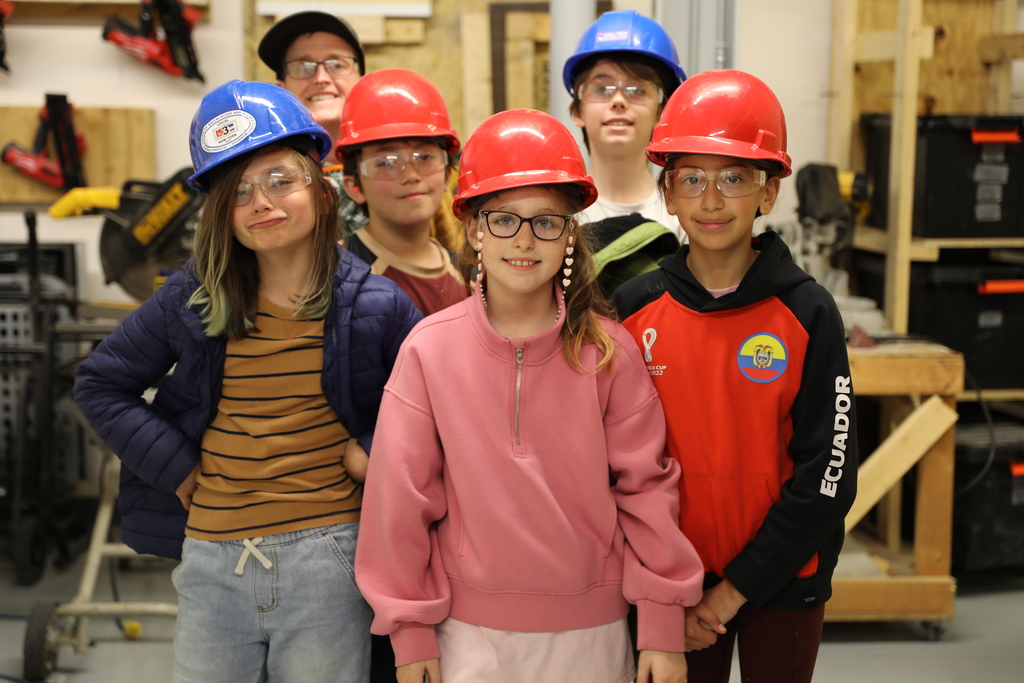 a group photo of some of the students who worked on bird houses