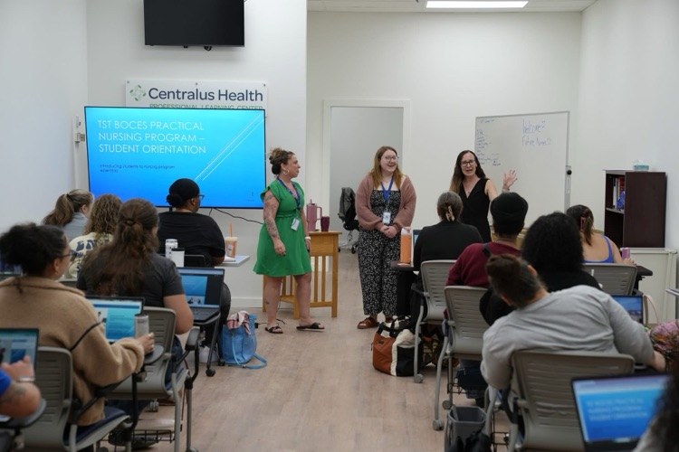 Students in the TST BOCES Practical Nursing Program sit in a classroom during orientation while instructors speak at the front of the room beside a presentation screen.