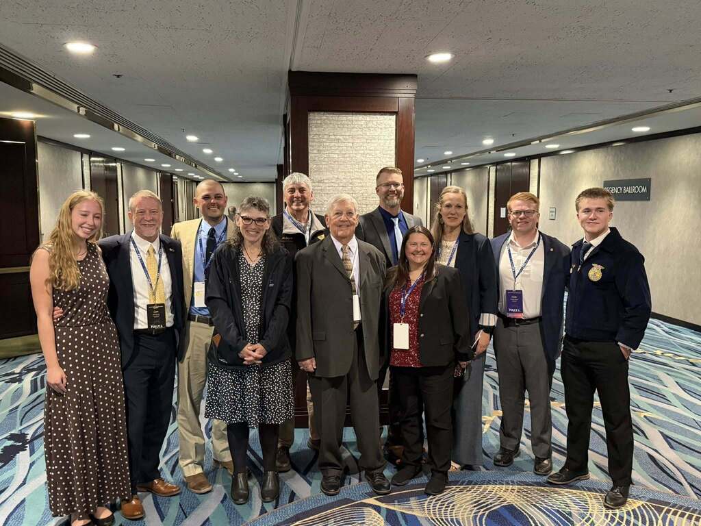 Michele Kline poses with family, colleagues, and supporters during the New York State FFA Hall of Fame induction ceremony.