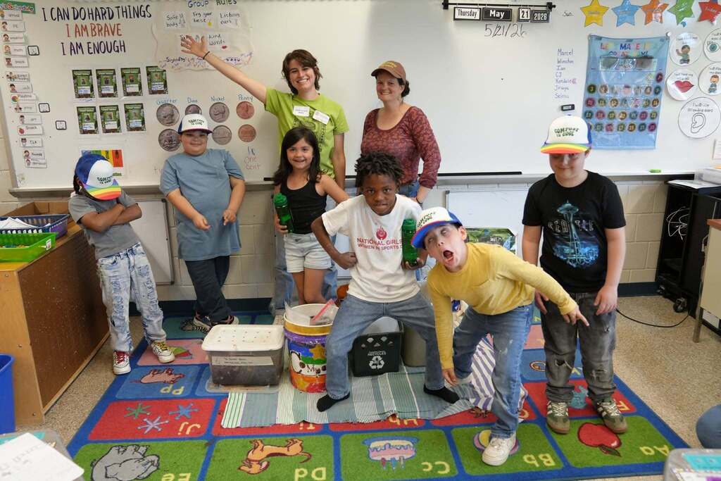 Students and Cornell Cooperative Extension educators pose together in the classroom following a year of learning about composting, recycling, and food waste reduction.
