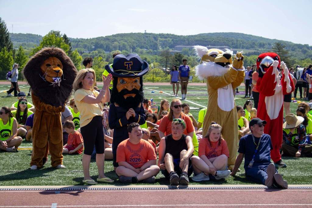 Students and school mascots gather on the field during opening ceremonies at the Dryden Games.