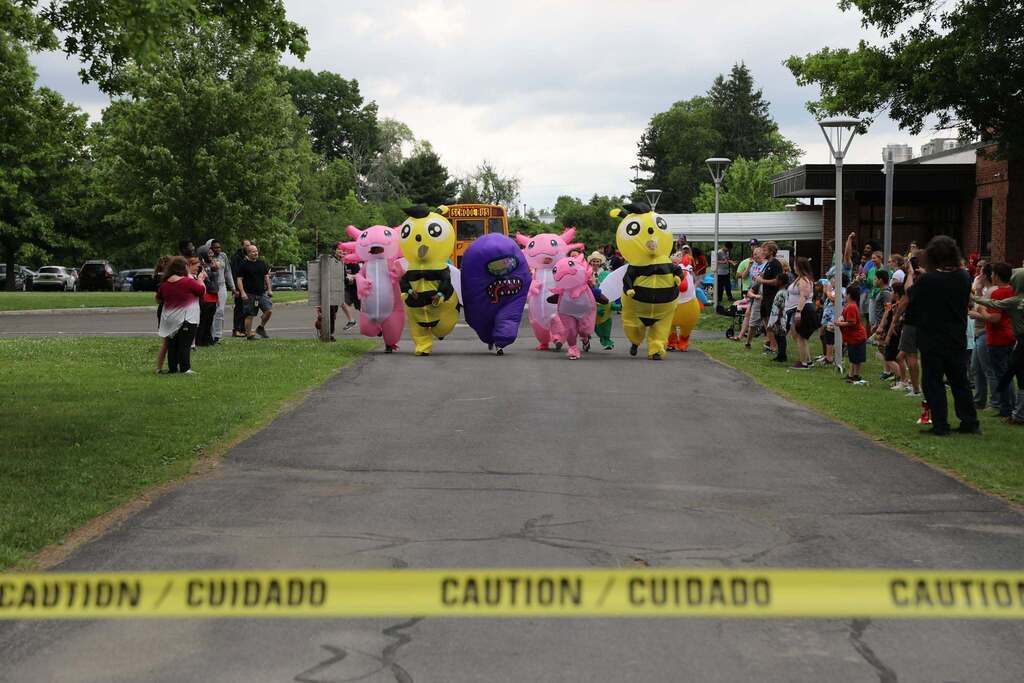 a group of costumed staff members racing