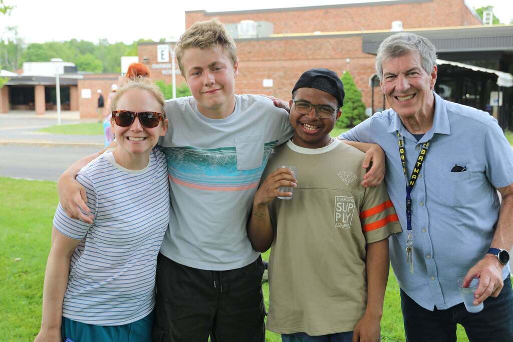 a group of students and staff posing for the camera