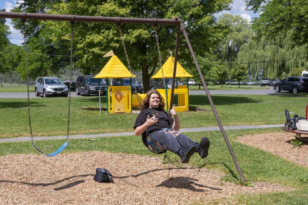 Student enjoys swinging at the playground during the Turning Point BBQ at Stewart Park.