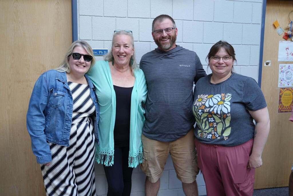 Four TST BOCES staff members smile together for a group photo during the Annual Hot Dog Day celebration.