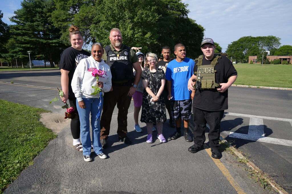 TST BOCES Summer School students and staff pose for a group photo with a police officer during Community Day.