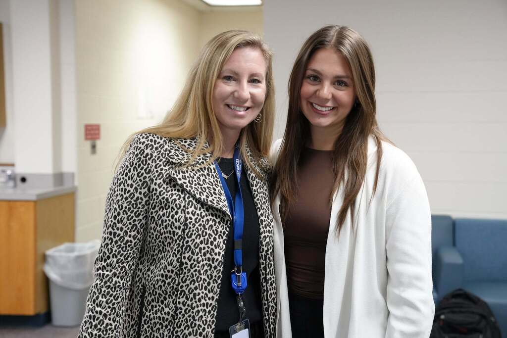 A TST BOCES staff member and a hiring event attendee smile together for a photo during the event.