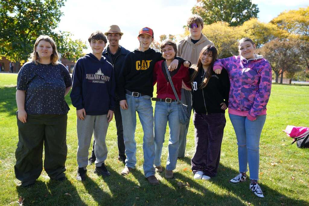 students smile with speaker who talked with students about her time hiking the Apalachin trail.