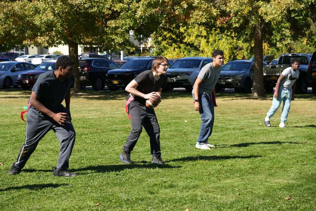 students stand on a line of scrimmage for flag football game at RAS