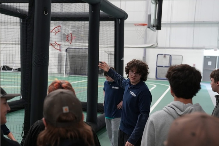 igh school students from TST BOCES P-TECH program demonstrating interactive projects—including Drone Soccer equipment to visiting students at a college manufacturing expo booth.