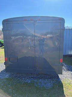 Rear view of the food trailer with double loading doors and newly painted dark gray exterior.