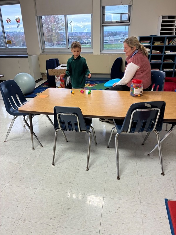 Student playing with teacher in Foundations program