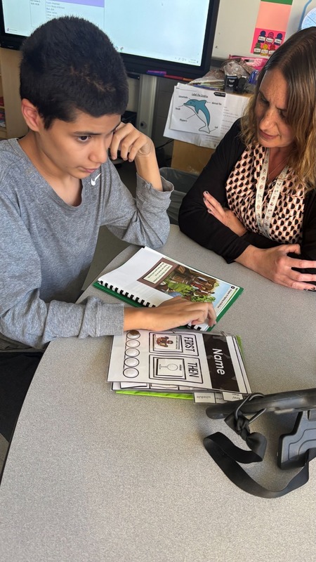student reading with teacher using new literacy program