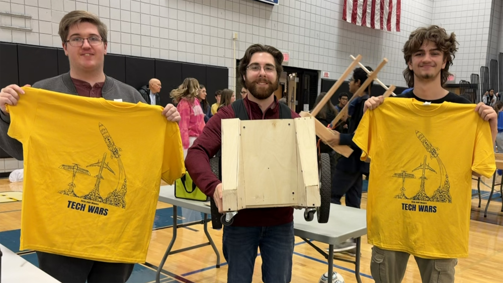 students and teacher pose at tech wars