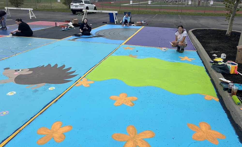 students pose with painted parking spots