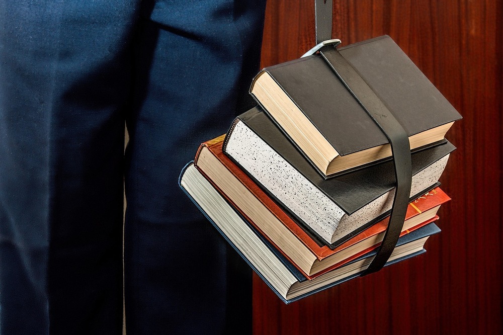 stack of books held together by a belt