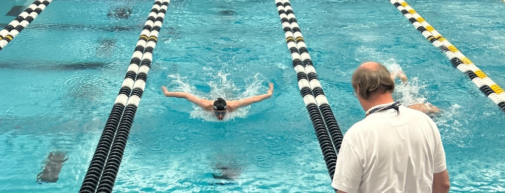 Student qualifier swims at a meet.