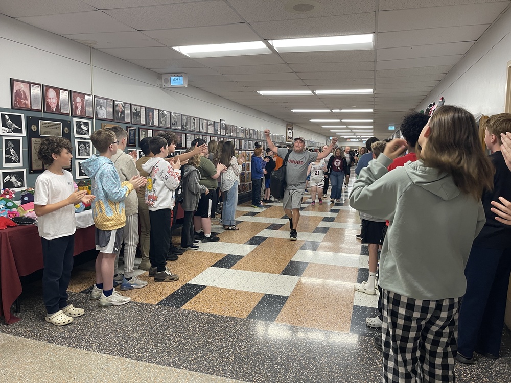 crowd lines hallways cheering for unified team