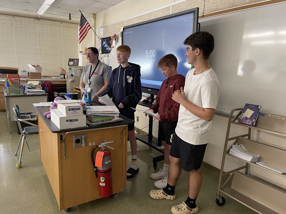 teacher and web leaders stand in front of classroom during WEB tapping ceremony