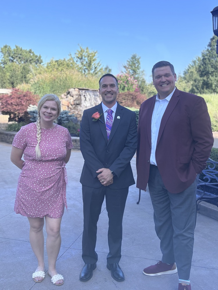 board president, board member and superintendent pose for picture outside