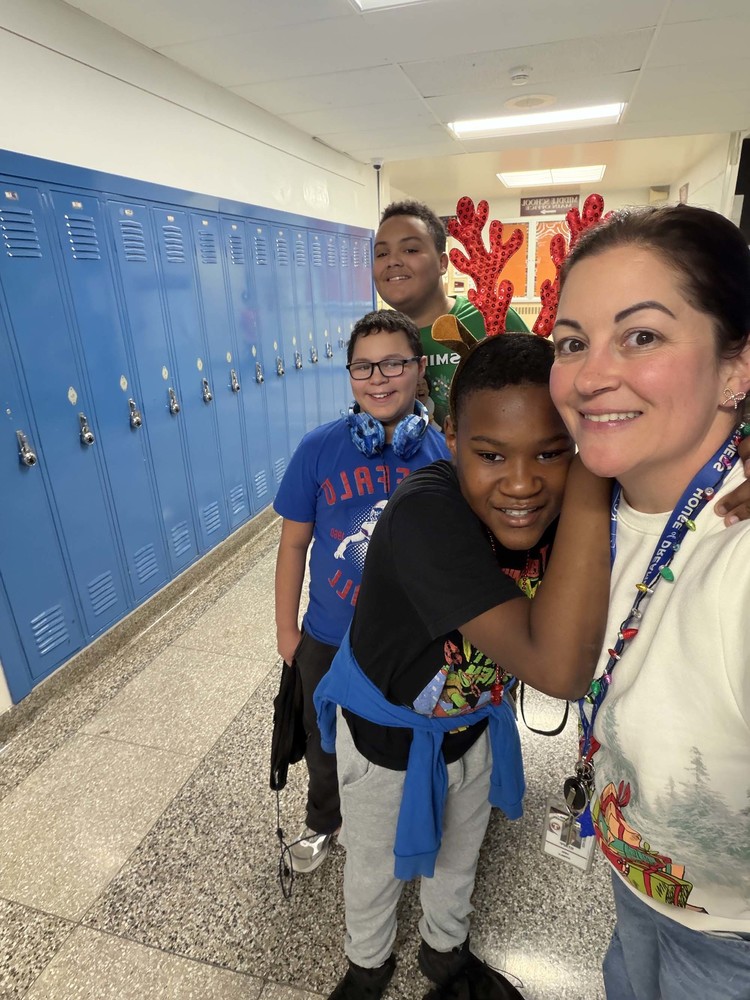 principal and students pose in holiday gear