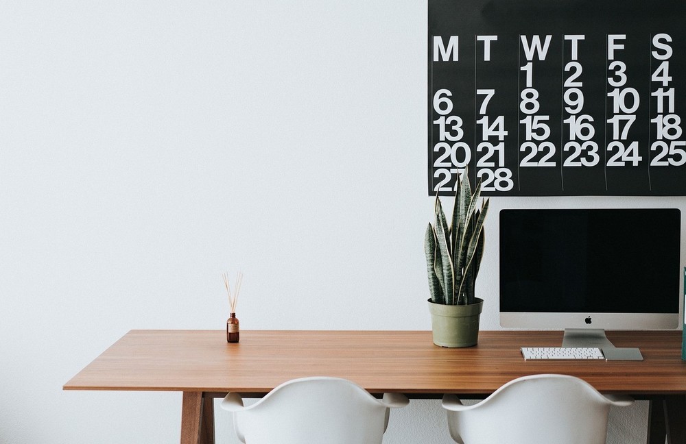 calendar in background with table and chairs in foreground