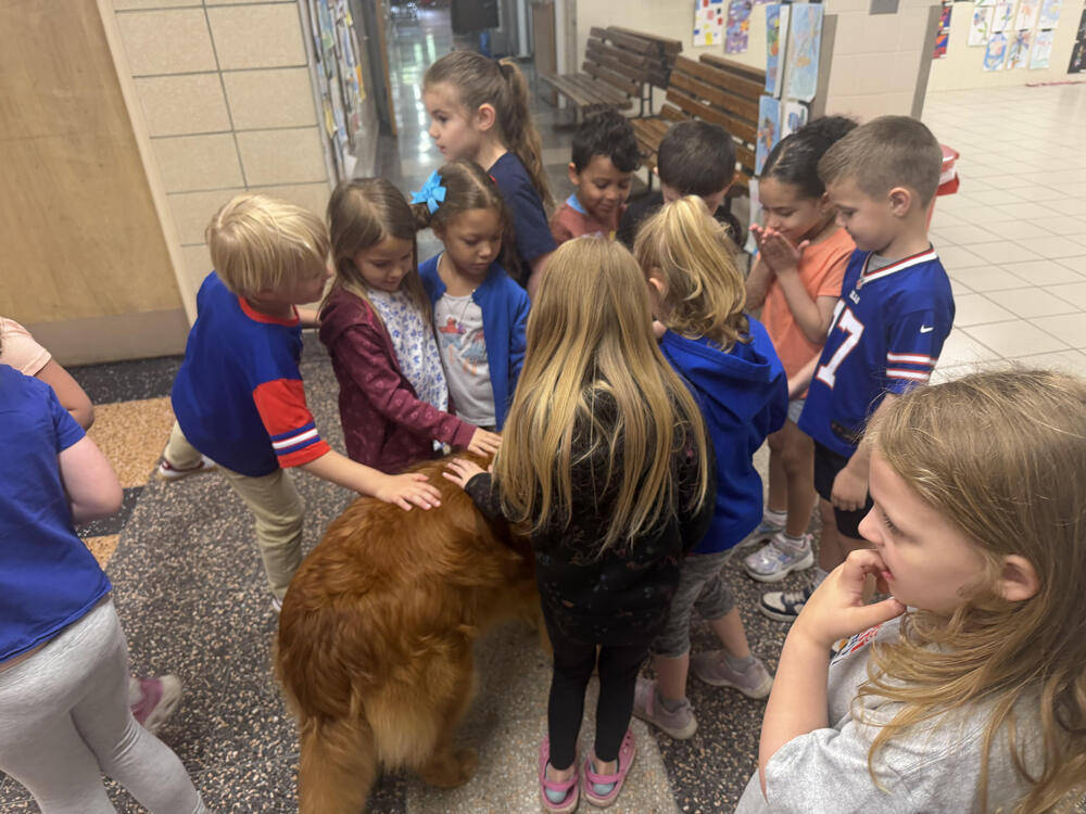 TES students crowd around Maverick for pets