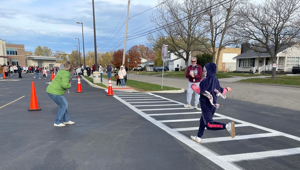 student runs to the finish line
