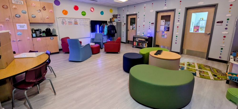 image of inside family support center with brightly colored tables and chairs
