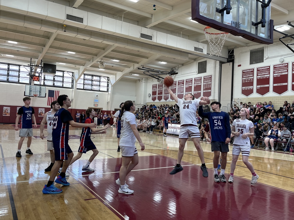 students playing on basketball court against north tonawanda
