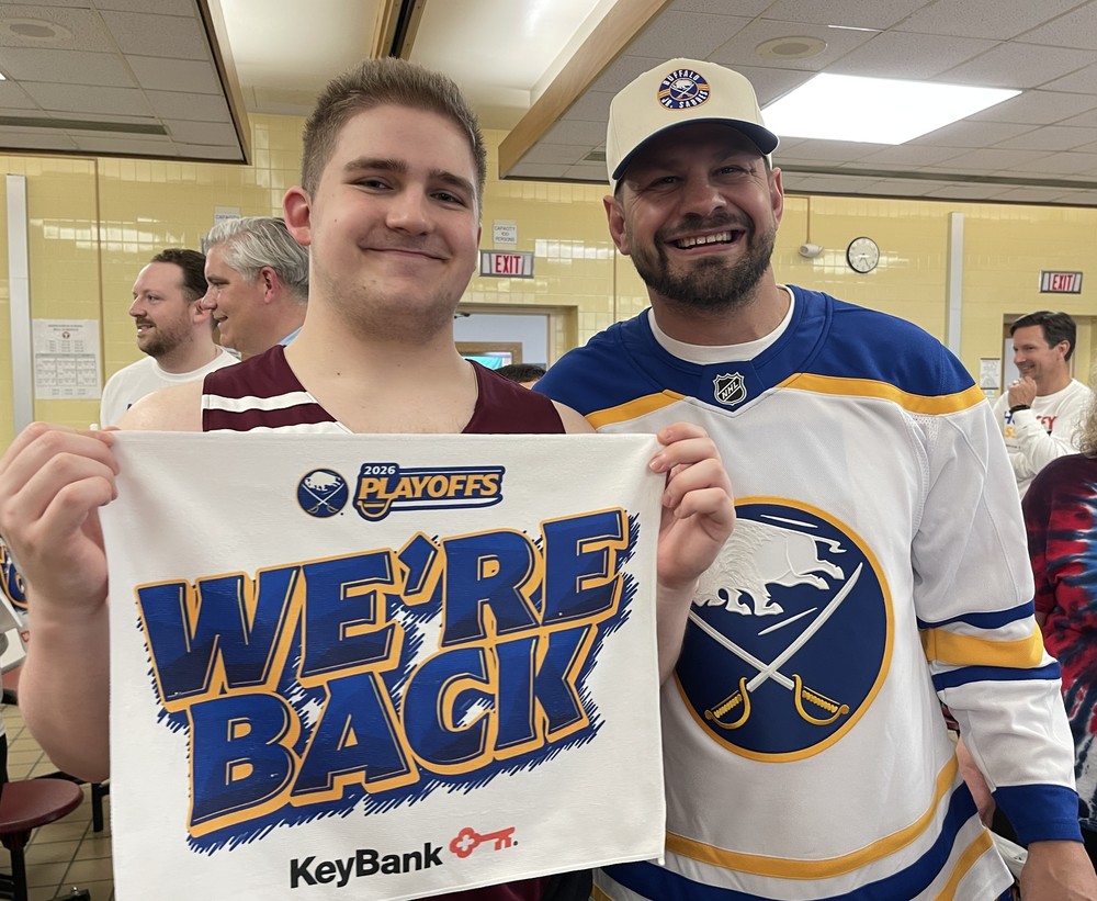 patrick kaleta poses with tonawanda student as student holds upbuffalo sabres "we're back" playoff towels