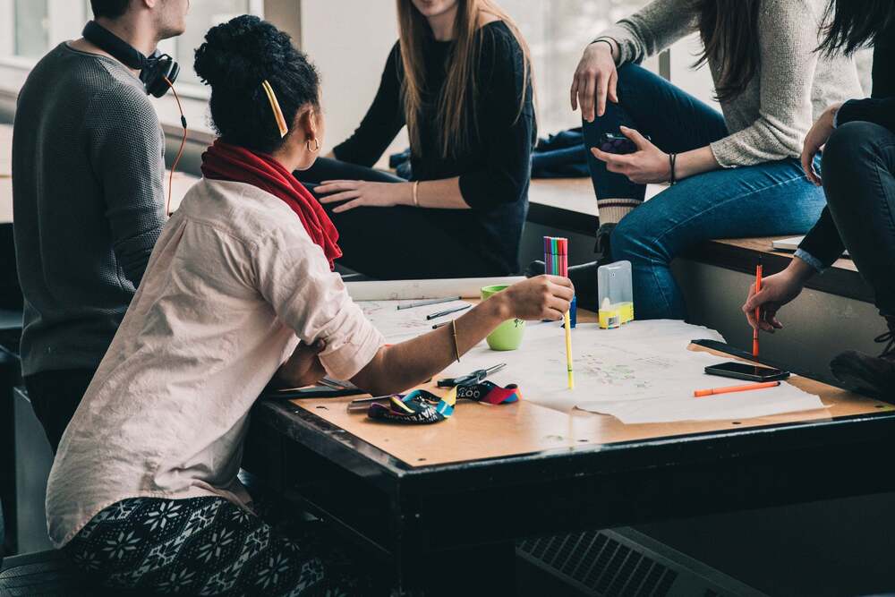 people sitting at table working on project